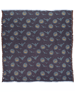 A square woven textile with fringe on all sides, featuring a repeating Halloween pattern of smiling jack-o'-lantern pumpkins and gray bats on a dark charcoal background.
