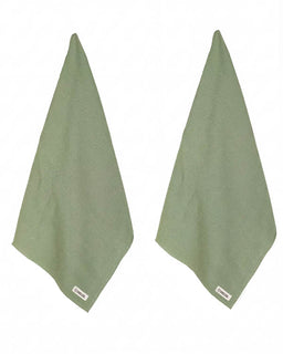 Two green towels on a white background