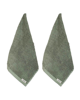 Two green textured towels on a white background
