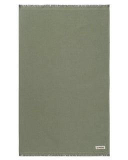 Green towel with a brand label on a white background