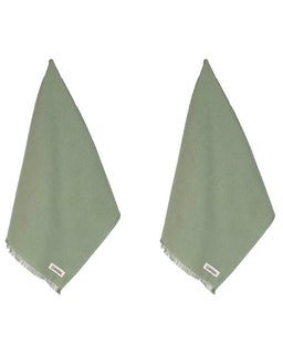 Two green towels with labels on a white background