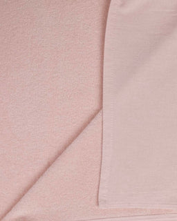 Close-up of light pink fabric with a subtle texture