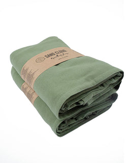 Folded green towel with a brown band labeled 'Sand Cloud' on a white background