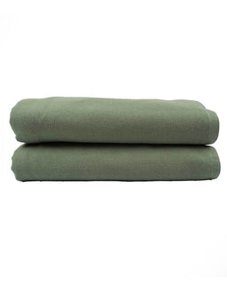 Two folded green towels on a white background