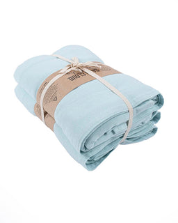 Light blue towels wrapped with a brown ribbon on a white background