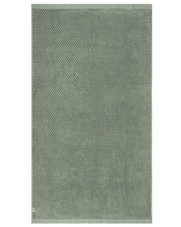 Green textured towel on a white background