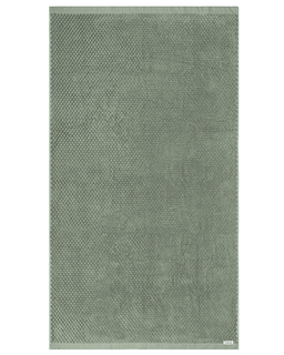 Green textured towel on a white background