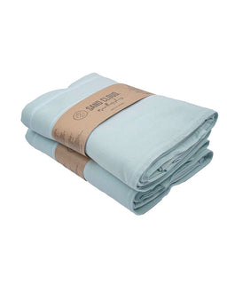 Folded light blue towel with a brown label on a white background