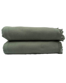 Stack of green textured blankets on a white background