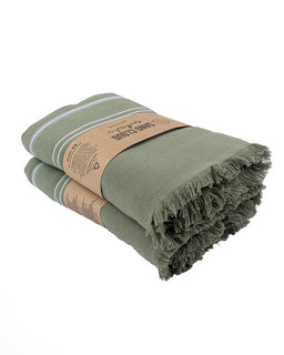 Two green towels with fringes on a white background