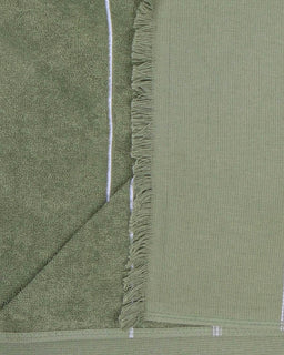 Green towel with frayed edge on a green background