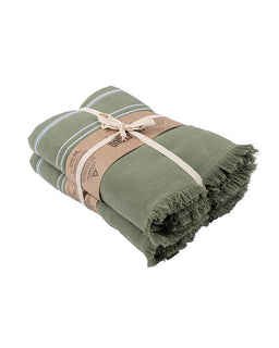 Folded green towel with a brown strap on a white background