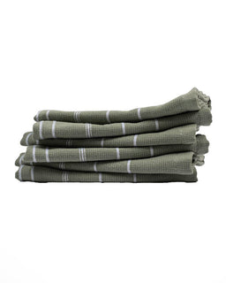 Stack of green towels with white stripes on a white background