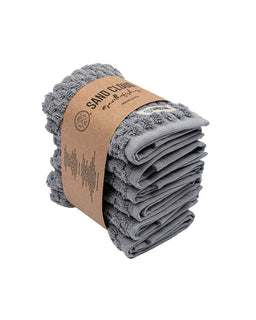 Folded gray towel with a cardboard wrap on a white background