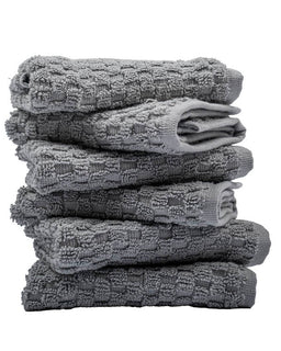 Stack of gray textured towels on a white background
