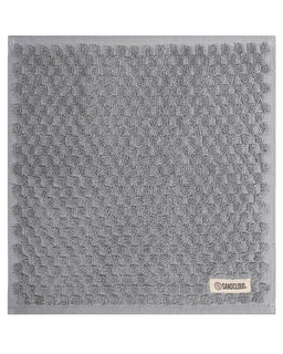 Gray textured washcloth with a brand label on a white background