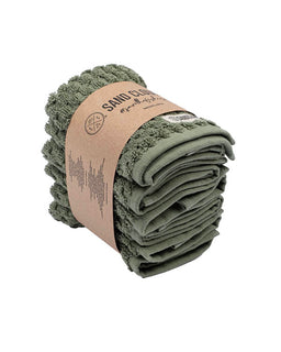 Green towel rolled up with a cardboard wrap on a white background