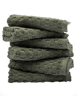 Stack of green towels on a white background