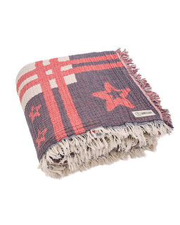 Woven towel with star pattern and frayed edges on a white background