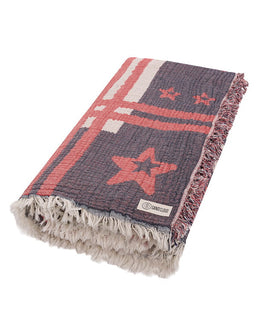 Beach towel with star pattern and brand label on a white background