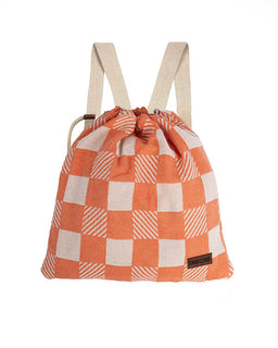Orange and white checkered drawstring bag with beige straps on a white background