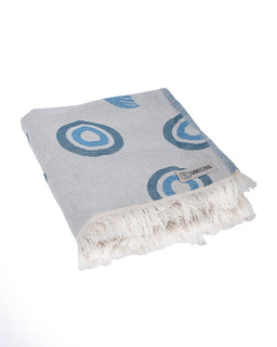 Gray towel with blue circular patterns and white fringe on a white background