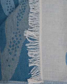 Close-up of a blue and gray patterned fabric with frayed edge