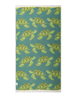 Teal towel with green turtle pattern on a white background