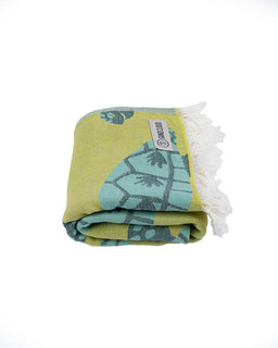 Folded towel with green and blue pattern on a white background