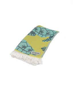 Folded towel with green and yellow pattern on a white background