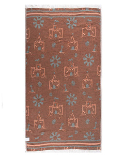 Brown towel with castle and sun pattern on a white background