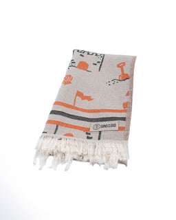 Beige towel with orange and black patterns on a white background
