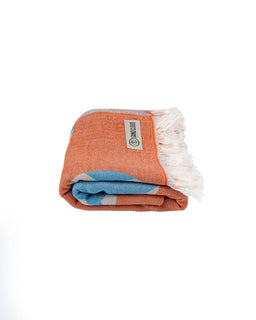 Folded towel with a brand label on a white background