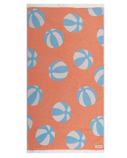 Beach towel with blue and white ball pattern on an orange background