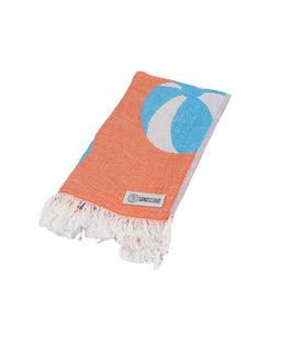 Orange towel with blue crescent moon design on a white background