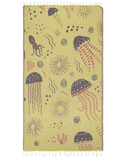A lime green beach towel with a marine life design, including jellyfish and sea anemones, with twisted tassels at the bottom.