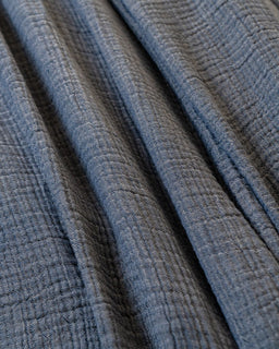 Close-up of textured blue fabric with a subtle pattern