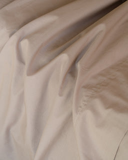 Close-up of beige fabric with subtle texture