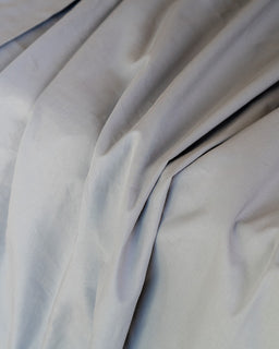 Close-up of light gray fabric with folds