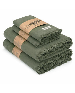 Stack of green towels with brown labels on a white background