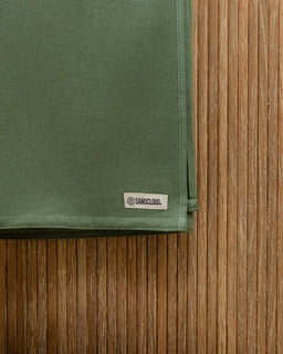 Green fabric with a label on a wooden surface