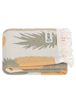 Folded towel with palm tree design and 'Sand Cloud' label on a white background