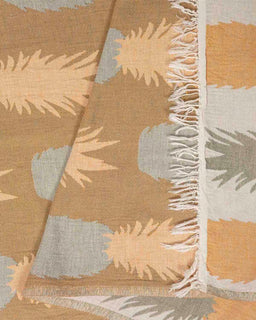 Textile with leaf pattern and frayed edge on a brown background