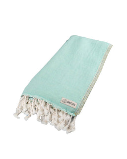 Turquoise towel with white tassels on a white background
