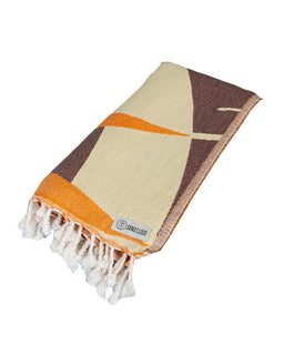 Woven blanket with geometric pattern and tassels on a white background