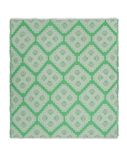 Green and white patterned blanket on a white background