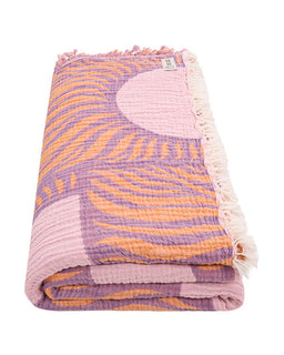 Folded blanket with purple and orange pattern on a white background