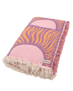 Colorful patterned blanket with fringes on a white background