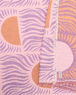 Pink and purple patterned blanket with geometric shapes