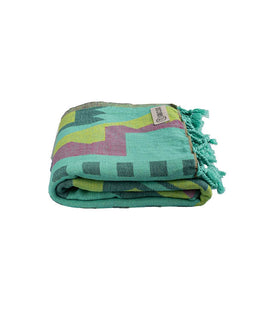 Folded colorful towel with geometric pattern on a white background